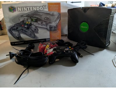 Retro gaming console bundle featuring a Nintendo 6...
