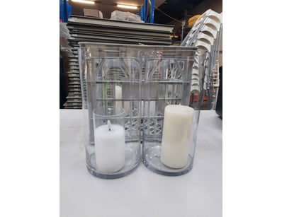 Four candles in cleat glass container.

SOLD AS ...