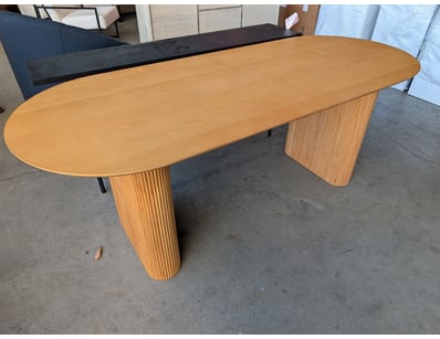Modern oval dining table featuring timber construc...