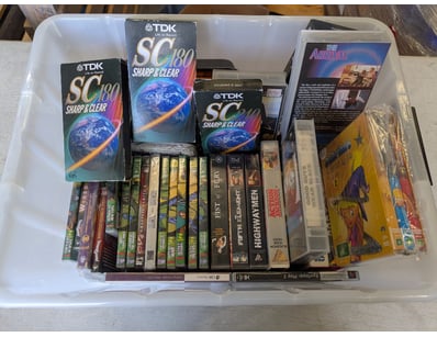 Extensive vintage VHS tape collection featuring ap...