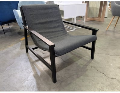 Mid-century modern lounge chair featuring a charco...