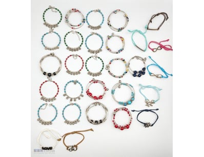 EXTENSIVE COLLECTION OF BEADED BRACELETS AND CHARM...
