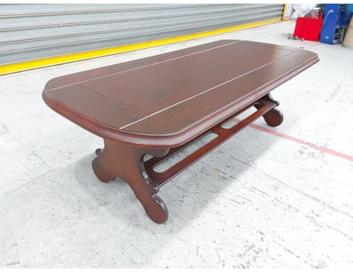 Elegant timber dining table featuring a rich mahog...