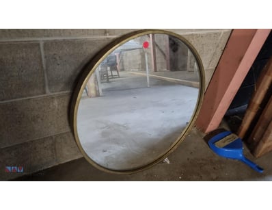 Vintage brass-framed mirror with Features a brass ...