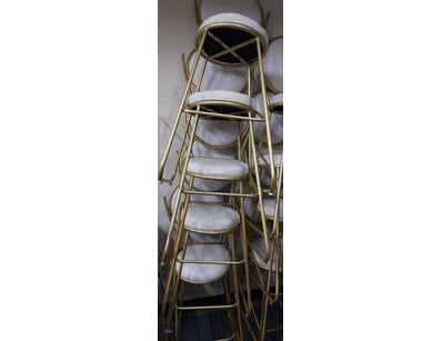Set of stackable  chairs featuring brass-toned met...