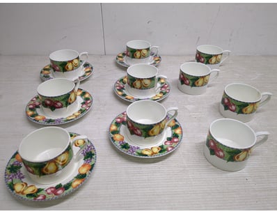 Tea set featuring a charming fruit festival design...