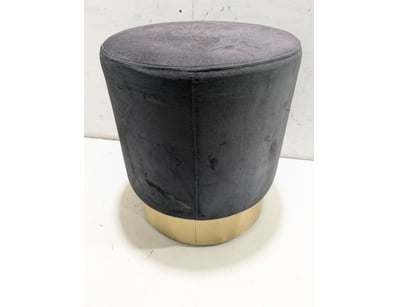 Contemporary cylindrical ottoman featuring a black...