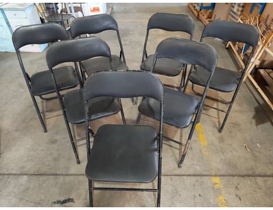 Set of 7 black padded folding chairs featuring met...