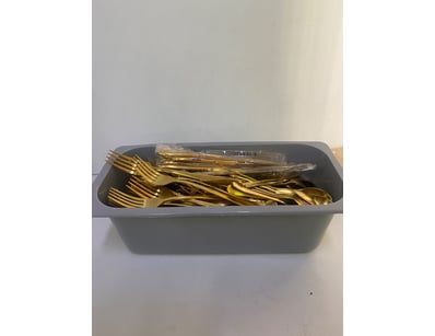 Lot of gold coloured cutlery. Forks, knives, spoon...