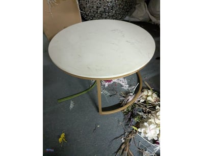 Modern round side table featuring a white marble-e...