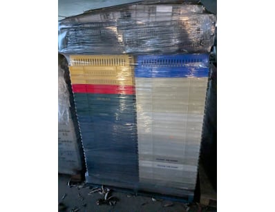 Large pallet of plastic storage crates in assorted...