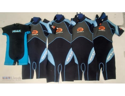 Lot of five wetsuits in various styles and sizes. ...