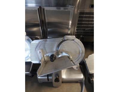 Lot of commercial-grade meat slicers featuring sta...