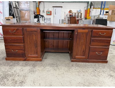 Substantial executive desk features a spacious wor...