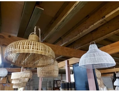 two woven pendant light fixtures featuring mixed m...