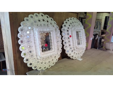 Pair of decorative wall mirrors featuring ornate c...