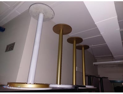 Modern pedestal table featuring a white marble-eff...