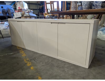 Modern white timber sideboard cabinet featuring fo...