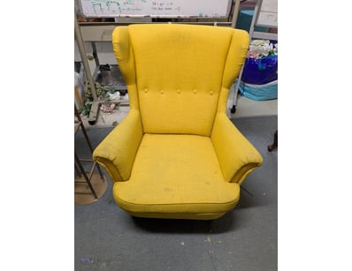 Striking yellow upholstered wingback armchair feat...