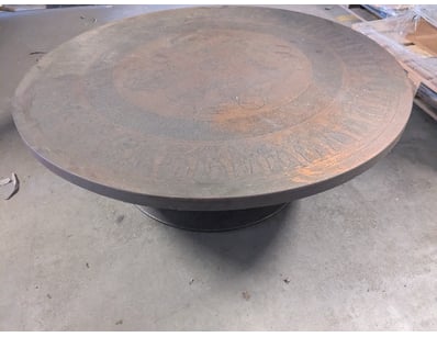 Striking circular coffee table featuring an elabor...