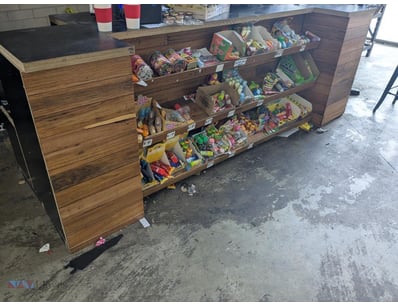 Wooden retail display counter with integrated shel...