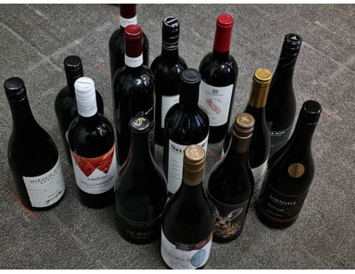 A curated collection of 14 premium red wine bottle...