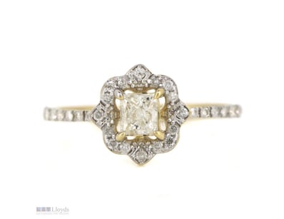 14K YELLOW GOLD AND DIAMOND HALO RING.      

The ...
