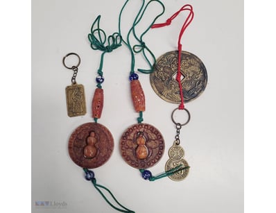 COLLECTION OF JADE CARVED CINNABAR AND BRASS PENDA...