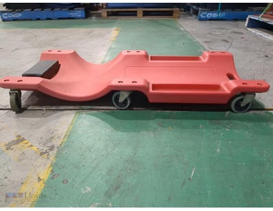 Red plastic mechanic's creeper with ergonomic wave...