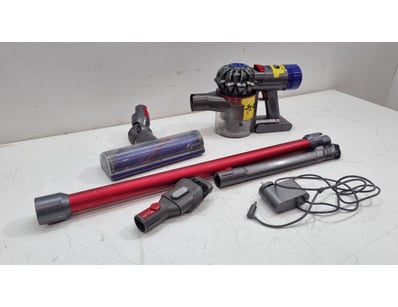 Dyson V11 cordless vacuum cleaner system in red an...
