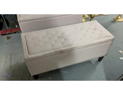 Elegant cream upholstered storage ottoman featurin...
