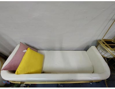 Modern upholstered daybed featuring a curved, padd...