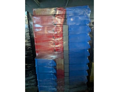 Pallet of plastic storage crates in red and blue, ...