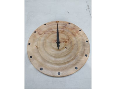 Handcrafted wooden wall clock featuring a natural ...