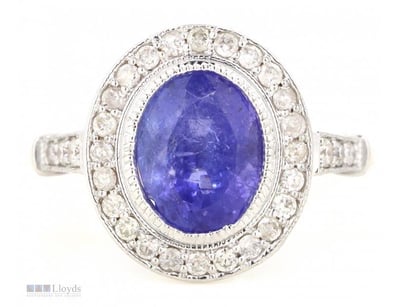 14CT ROSE GOLD, TANZANITE AND DIAMOND, HALO RING.
...