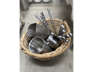 Woven wicker basket containing bread knifes and se...