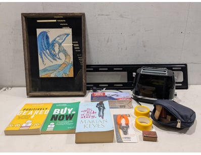 Eclectic collection of household items and books. ...