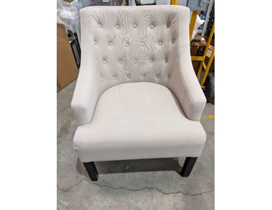 Elegant cream upholstered accent chair featuring b...