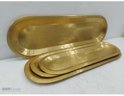 Nested elongated oval brass trays featuring hammer...