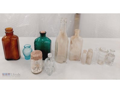COLLECTION OF GLASS BOTTLES IN VARIOUS SHAPES AND ...