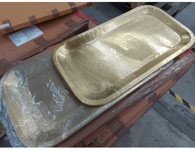 Pair of decorative serving trays featuring elegant...