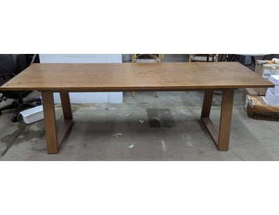 Substantial timber dining table featuring a light ...