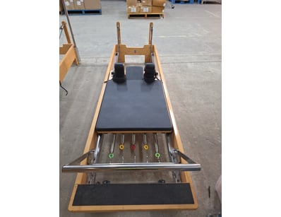 Pilates Master reformer in natural wood constructi...