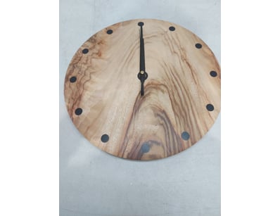 Handcrafted wooden wall clock featuring a camphor ...