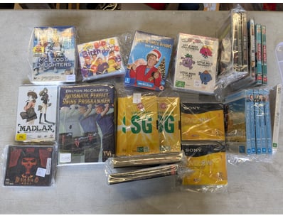Extensive media collection comprising DVDs, VHS ta...