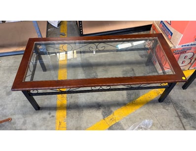 Glass-top coffee table featuring a wooden style fr...