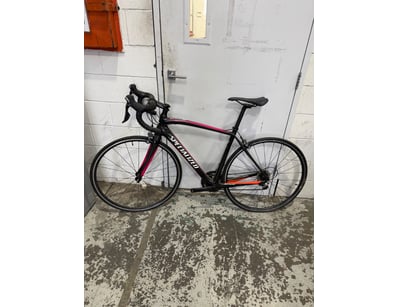 Specialized road bike featuring a black frame with...