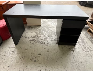 Modern black desk featuring a light grey wood-grai...