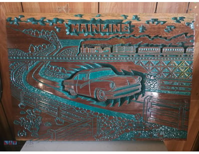 Handcrafted wooden relief carving featuring a vint...
