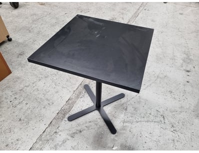 Black pedestal bistro table featuring a square top...